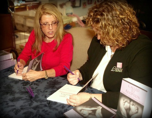 Authors Mardie Caldwell and Heather Featherston signing books