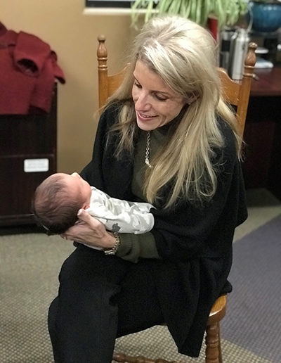 Photos Adoption Expert Mardie Caldwell enjoys holding a newly adopted baby