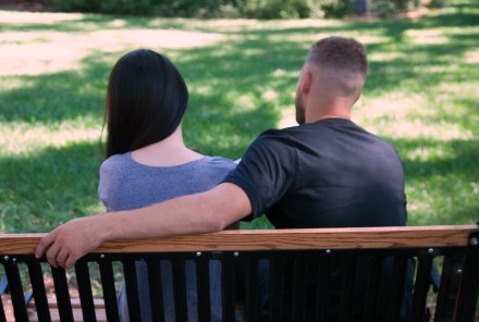 Birth parents talking in a park