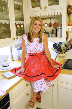 Mardie seated on her kitchen counter in an apron